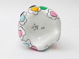 a small white bowl with colorful hearts on it