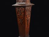 une image représentant un socle en bois orné d'un motif sculpté