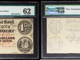 three different types of paper money are on display in a display case