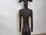 an old wooden statue of a man with a hat on his head