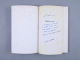 an open book with a handwritten note on it