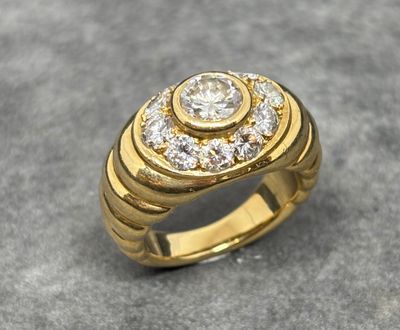 an image of a gold ring with a diamond center