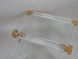 a clear glass table with two wooden legs on a white background