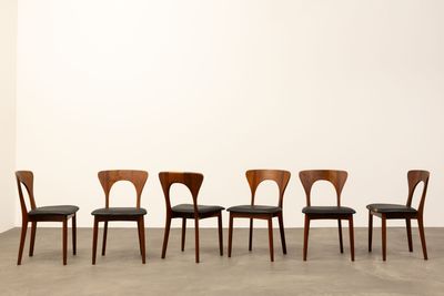 a set of six dining chairs with black leather upholstered seats