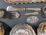 a table with a lot of silver items on it