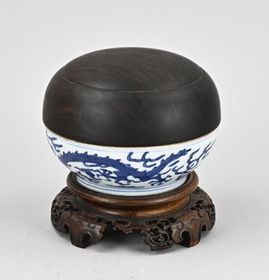 chinese blue and white porcelain bowl on wooden stand on white background