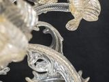 a glass chandelier with flowers and leaves on it