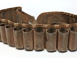 a belt made out of wooden pipes on a white surface