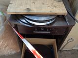 a wooden box with a pan inside of it next to a red and white tape