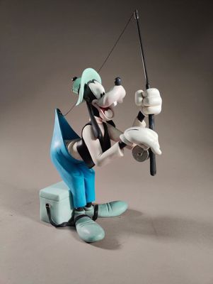 figurine of a man fishing with a fishing pole