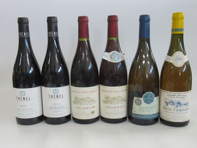 several bottles of wine are lined up in a row on a table