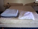 a bed with two pillows on top of it in a room