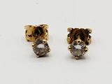 pair of diamond stud earrings on white background
