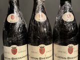 six bottles of wine are lined up in a row
