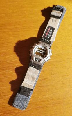 a close up of a watch on a wooden table