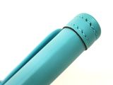 a blue pen that is sitting on a table