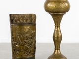 pair of brass candlesticks with relief of a battle scene