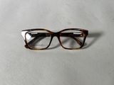an image of a pair of glasses sitting on a white surface