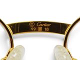 the glasses are made of gold and white marbles with a clear lens