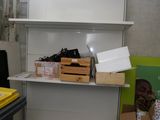 a white shelf with boxes and boxes on it in a room