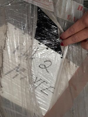 a person that is putting something in a plastic bag