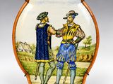 une photo d'une assiette décorative sur laquelle sont représentés un homme et une femme