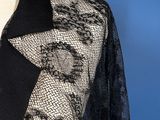 a close up of a black and white lace jacket on a mannequin dummy