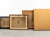 several pieces of art sitting on top of a cement floor next to a wall