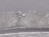 a close up of a glass bowl with a flower decoration on it