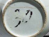 a close up of a white vase with black writing on it