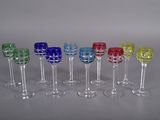several different colored wine glasses are lined up in a row