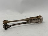 silverware spoon and spoon rest on a white surface