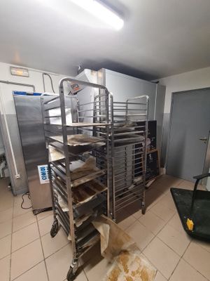 an image of a kitchen with a bunch of trays of food on the floor