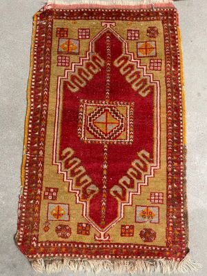 rug on the floor is red and beige with a geometric design