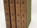 three books are stacked on top of each other on a white surface