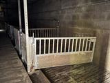 a baby crib in the corner of a barn