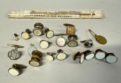 many different types of buttons and a ruler on the table