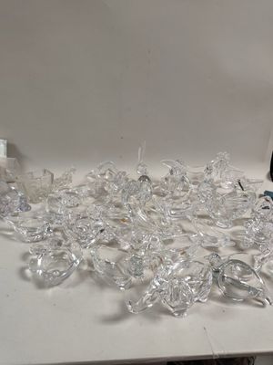 a pile of clear glasses sitting on a table