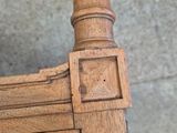 a close up of a wooden chair with a wooden seat