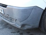 a close up of the front bumper of a white van