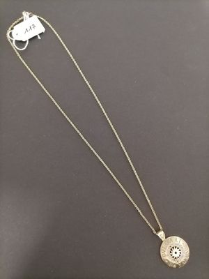 a silver necklace with a medallion pendant on a chain