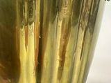 brass plated vase on stand on white surface with white background