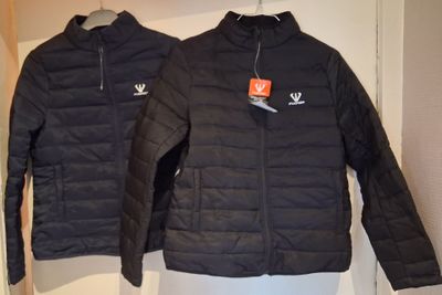 pair of black jackets on a mannequin display in a clothing store