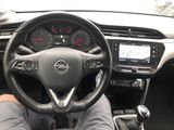 someone is sitting in the driver ' s seat of a car with their feet on the steering wheel