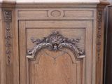 a wooden cabinet with carvings on the top of it