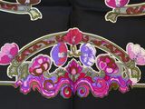 a close up of a black dress with pink and purple flowers on it