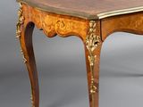 a small table with a wooden top on a grey background
