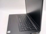 a laptop computer sitting on a table with a keyboard