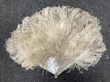 a pile of white yarn on the ground next to an umbrella