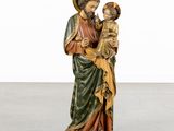 an image of a statue of jesus holding a child